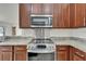 Updated kitchen features granite countertops, stainless steel appliances, and wood cabinetry at 6425 Clair Shore Dr, Apollo Beach, FL 33572