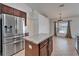 Eat-in kitchen with stainless steel refrigerator and granite island at 6425 Clair Shore Dr, Apollo Beach, FL 33572