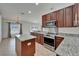 Modern kitchen featuring stainless steel appliances, granite countertops, and a kitchen island at 6425 Clair Shore Dr, Apollo Beach, FL 33572