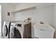 Practical laundry room with modern washer and dryer, sink, and overhead storage at 6425 Clair Shore Dr, Apollo Beach, FL 33572