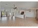 Spacious living room with tiled floors, vaulted ceilings, and views of the kitchen and front yard at 6425 Clair Shore Dr, Apollo Beach, FL 33572
