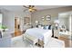 Serene main bedroom features neutral colors, a ceiling fan, and an ensuite bathroom at 6425 Clair Shore Dr, Apollo Beach, FL 33572