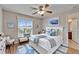 Main bedroom with ceiling fan, natural light, and ensuite bathroom at 6425 Clair Shore Dr, Apollo Beach, FL 33572