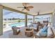 Spacious covered patio with outdoor furniture, ceiling fans, and pool views at 6425 Clair Shore Dr, Apollo Beach, FL 33572