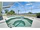 Pool area with a screened lanai featuring a spa, perfect for relaxing and entertaining guests at 6425 Clair Shore Dr, Apollo Beach, FL 33572