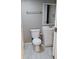 This is a bathroom featuring a white vanity, toilet, and tile flooring at 6434 Old Main St, New Port Richey, FL 34653