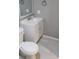 Bathroom featuring a white vanity, toilet, and tile flooring at 6434 Old Main St, New Port Richey, FL 34653