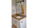 Updated bathroom vanity with granite countertop, framed mirror, and modern fixtures with storage at 6434 Old Main St, New Port Richey, FL 34653