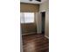 Cozy bedroom with wood-look flooring, ceiling fan, closet and natural light from a window at 6434 Old Main St, New Port Richey, FL 34653