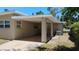 A view of the exterior featuring a covered patio at 6434 Old Main St, New Port Richey, FL 34653