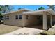 A view of the exterior featuring a covered patio at 6434 Old Main St, New Port Richey, FL 34653