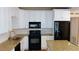 Spacious kitchen featuring granite countertops, subway tile backsplash, and a full suite of black appliances at 6434 Old Main St, New Port Richey, FL 34653