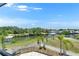 Scenic backyard view featuring a waterfront vista with palm trees and a white picket fence at 6522 Simone Shores Cir, Apollo Beach, FL 33572