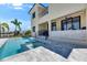 View of the back of the home featuring a pool, patio, and covered outdoor areas at 6522 Simone Shores Cir, Apollo Beach, FL 33572
