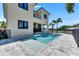 Back of house featuring a pool, patio, and covered lanai with outdoor seating and kitchen at 6522 Simone Shores Cir, Apollo Beach, FL 33572