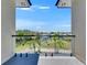Beautiful balcony view overlooking the canal with glass railings and tiled floor at 6522 Simone Shores Cir, Apollo Beach, FL 33572