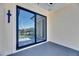 Covered balcony with tile flooring and large glass sliding doors to enjoy the outside view at 6522 Simone Shores Cir, Apollo Beach, FL 33572