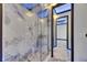 Contemporary bathroom with marble shower enclosure and modern fixtures at 6522 Simone Shores Cir, Apollo Beach, FL 33572
