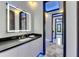 Modern bathroom featuring a sleek vanity, illuminated mirror, and stylish marble flooring at 6522 Simone Shores Cir, Apollo Beach, FL 33572