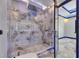 A lavish bathroom showcases marble walls, a glass shower, and a recessed showerhead at 6522 Simone Shores Cir, Apollo Beach, FL 33572