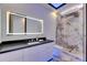 Bathroom with granite countertop, a glass shower, and modern LED lighting at 6522 Simone Shores Cir, Apollo Beach, FL 33572