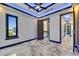 Bright bedroom with ceiling fan, window, and stylish marble floors, offering modern comfort at 6522 Simone Shores Cir, Apollo Beach, FL 33572