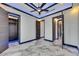 Large bedroom with marble flooring and an open closet featuring custom shelves at 6522 Simone Shores Cir, Apollo Beach, FL 33572