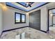 Elegant bedroom features marble floors, modern lighting, and a view of the outdoors at 6522 Simone Shores Cir, Apollo Beach, FL 33572