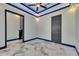 Bright bedroom featuring modern ceiling design, recessed lighting, fan and stylish doors with marble flooring at 6522 Simone Shores Cir, Apollo Beach, FL 33572
