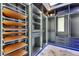Luxurious walk-in closet featuring custom shelves and drawers with modern lighting and a marble floor at 6522 Simone Shores Cir, Apollo Beach, FL 33572