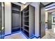 Spacious closet with modern shelving, illuminated base trim and marble floors in a luxurious home at 6522 Simone Shores Cir, Apollo Beach, FL 33572
