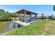 Image of a boat dock with a covered lift on a waterway at 6522 Simone Shores Cir, Apollo Beach, FL 33572