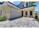 Beautiful home exterior featuring a spacious driveway and a modern design with architectural details at 6522 Simone Shores Cir, Apollo Beach, FL 33572
