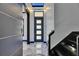 Sleek foyer showcasing a modern front door and marble flooring at 6522 Simone Shores Cir, Apollo Beach, FL 33572
