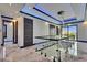 Bright upstairs hallway featuring glass railing, modern lighting and doors, and elegant marble flooring at 6522 Simone Shores Cir, Apollo Beach, FL 33572