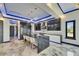 Modern kitchen with large island, unique lighting, stainless steel appliances, and sleek cabinetry at 6522 Simone Shores Cir, Apollo Beach, FL 33572