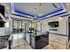 Bright kitchen with island, modern appliances, fireplace, and large sliding glass doors to the outdoor area at 6522 Simone Shores Cir, Apollo Beach, FL 33572
