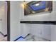 Modern laundry room with black countertop and cabinets featuring under-cabinet lighting at 6522 Simone Shores Cir, Apollo Beach, FL 33572