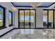 Contemporary living room with marble flooring, modern light fixtures, and sliding doors to the outside at 6522 Simone Shores Cir, Apollo Beach, FL 33572
