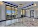 Contemporary living room with marble flooring, modern light fixtures, and sliding doors to the outside at 6522 Simone Shores Cir, Apollo Beach, FL 33572