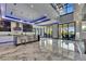 Contemporary living room with marble flooring, modern light fixtures, and sliding glass doors to the lanai at 6522 Simone Shores Cir, Apollo Beach, FL 33572