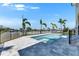 The swimming pool features an attached spa and deck area surrounded by palm trees at 6522 Simone Shores Cir, Apollo Beach, FL 33572