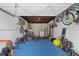 Basement gym with blue rubber flooring, weightlifting equipment, bicycles and neutral walls at 660 11Th N Ave, Safety Harbor, FL 34695