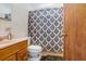 Bathroom featuring wood vanity, toilet and tile shower, complete with coordinating floral shower curtain at 660 11Th N Ave, Safety Harbor, FL 34695
