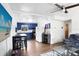 Open living room with wood floors, modern furniture and a view of the kitchen with blue cabinets at 660 11Th N Ave, Safety Harbor, FL 34695