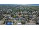 Aerial shot displays a community with lush greenery and residences with a large body of water in the distance at 7203 1/2 S West Shore Blvd, Tampa, FL 33616