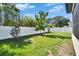 Green backyard with well-maintained grass and white vinyl fence offers serene outdoor retreat at 7203 1/2 S West Shore Blvd, Tampa, FL 33616