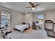 Bedroom with carpet, ceiling fan and windows, showing a dedicated workout area with equipment and natural light at 7203 1/2 S West Shore Blvd, Tampa, FL 33616