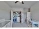 Spacious bedroom with an open closet, with carpet and a ceiling fan creating a comfortable atmosphere at 7203 1/2 S West Shore Blvd, Tampa, FL 33616