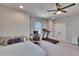 Carpeted bedroom showcasing a ceiling fan, and a workout area including a treadmill, computer and desk at 7203 1/2 S West Shore Blvd, Tampa, FL 33616